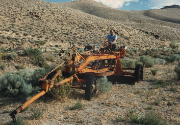 this grader is pulled by a vehicle