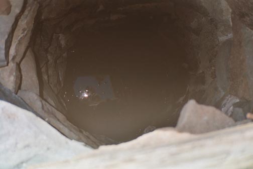 looking down this well you can see the reflection of our camera flash