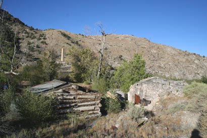 a view of the rear of the buildings with the smelter in the background